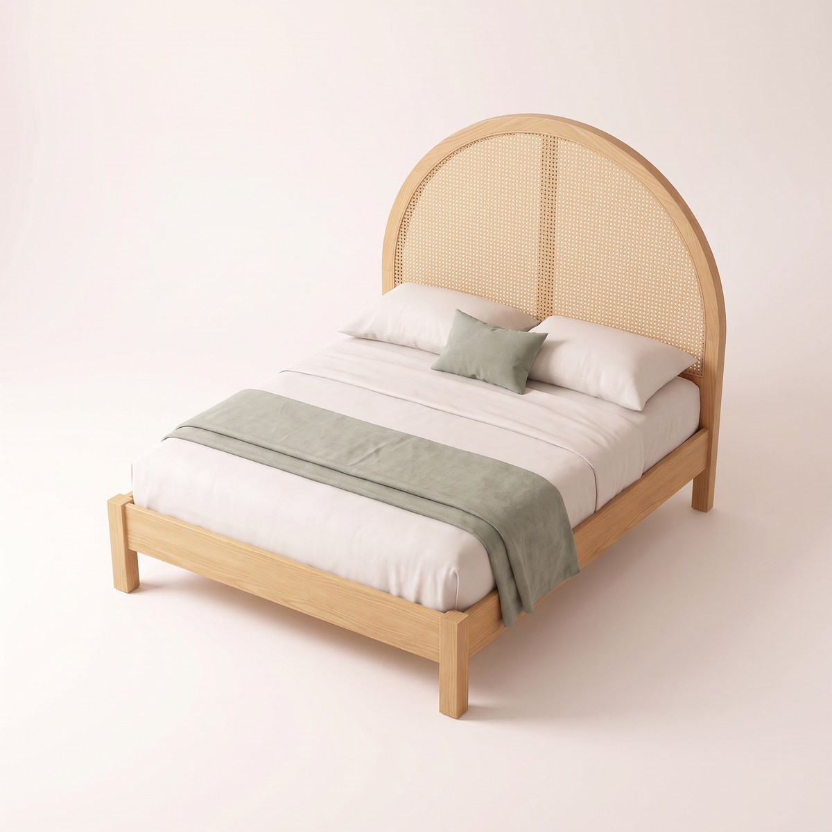 The Cloister Cane Bed from an elevated angle, showing ivory bedding with sage accents and the arched cane headboard