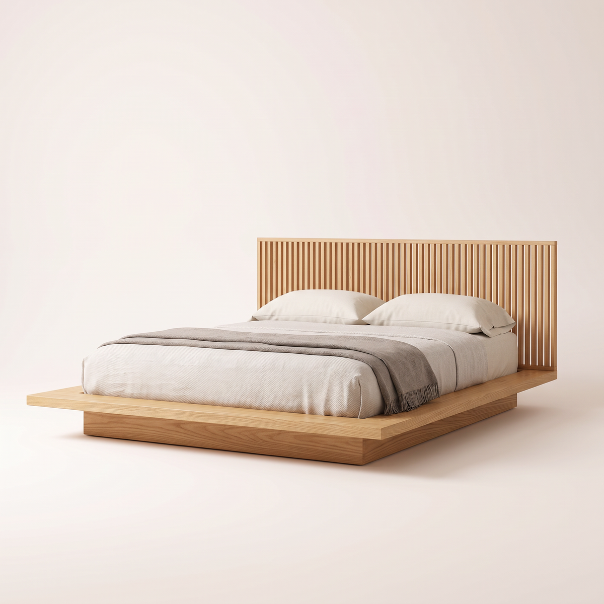 The Lowland Bed, a low honey solid ash platform bed with wide side ledges and slatted headboard, front three-quarter view