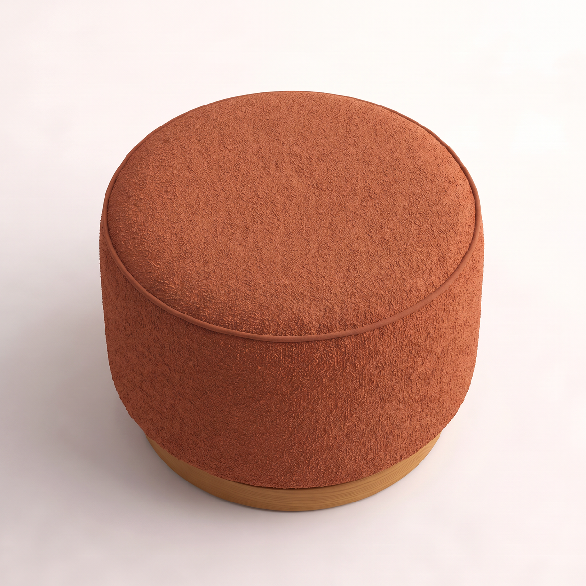 Tondo Rust round drum ottoman in rust bouclé, elevated view of the domed top and welt piping