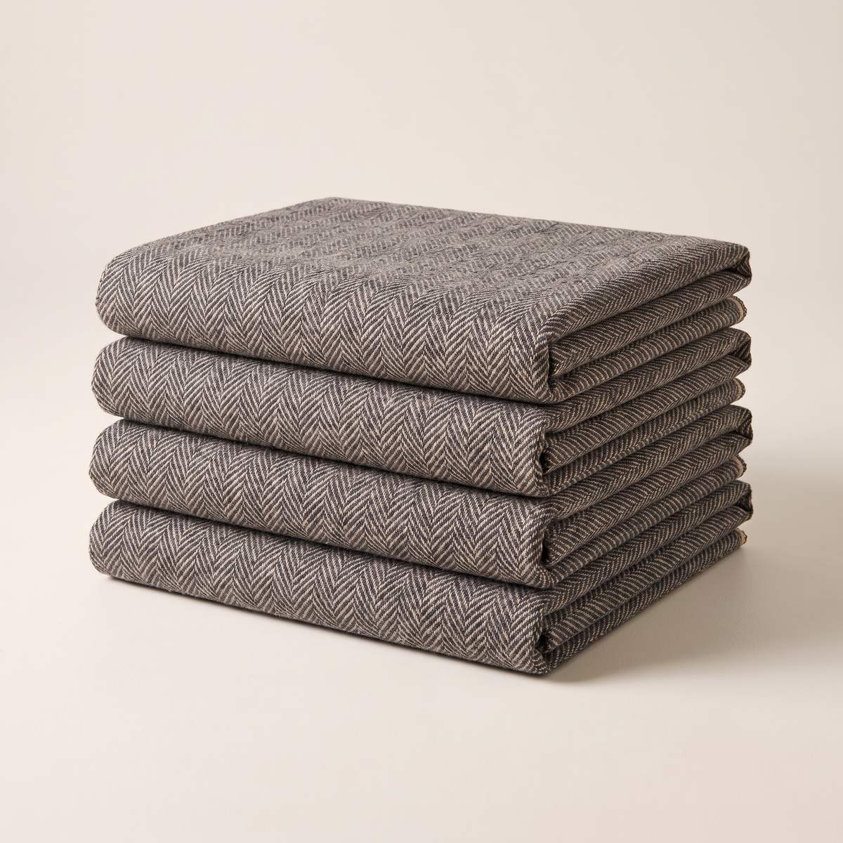 Tweed Herringbone upholstery fabric, neatly folded stack in charcoal and oat