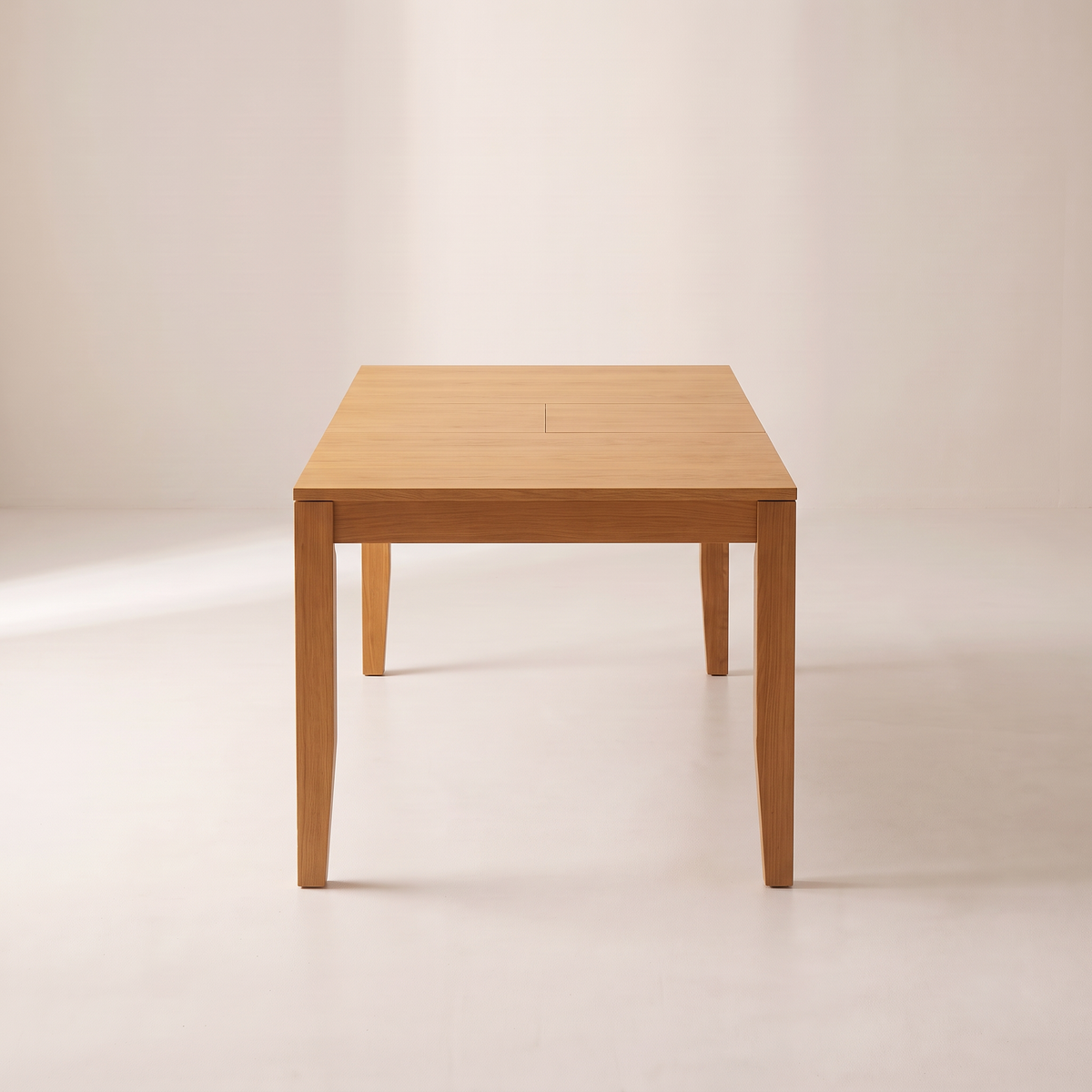 Unfold Extendable honey ash dining table seen from its short end