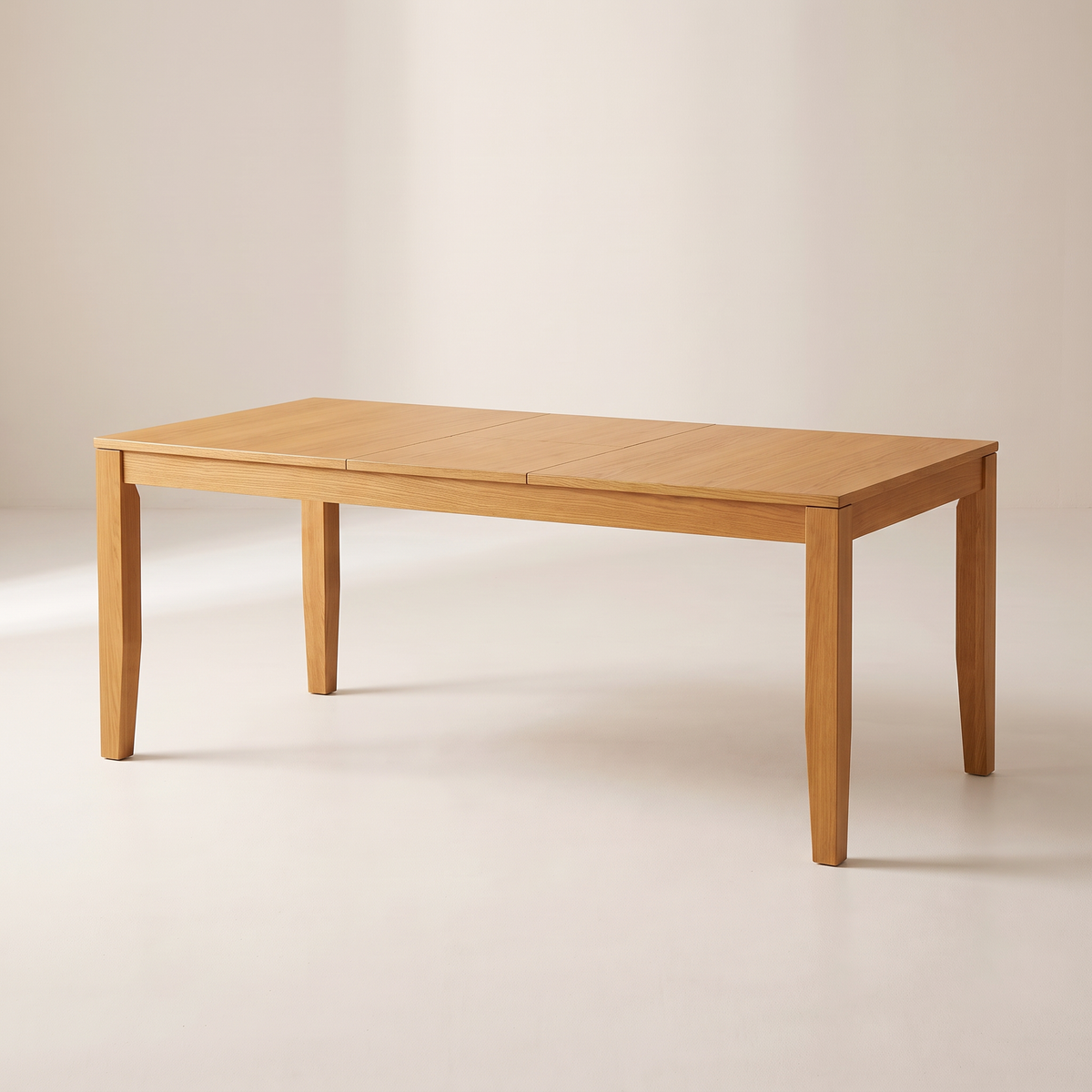 Unfold Extendable dining table in honey ash veneer, extended with its centre leaf, on four square tapered ash legs, front three-quarter view