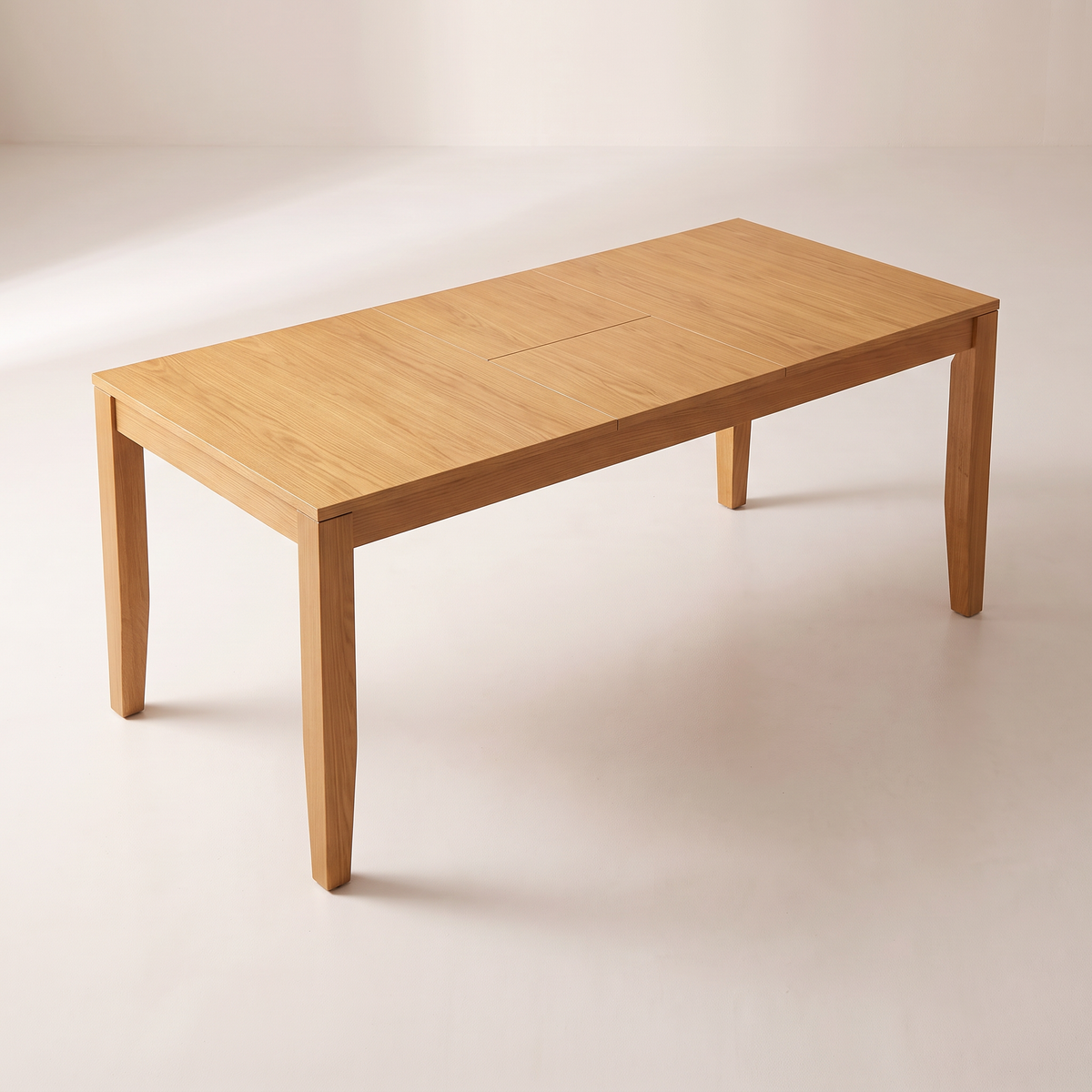 Unfold Extendable dining table showing its ash veneer top with the centre leaf seams, elevated three-quarter view