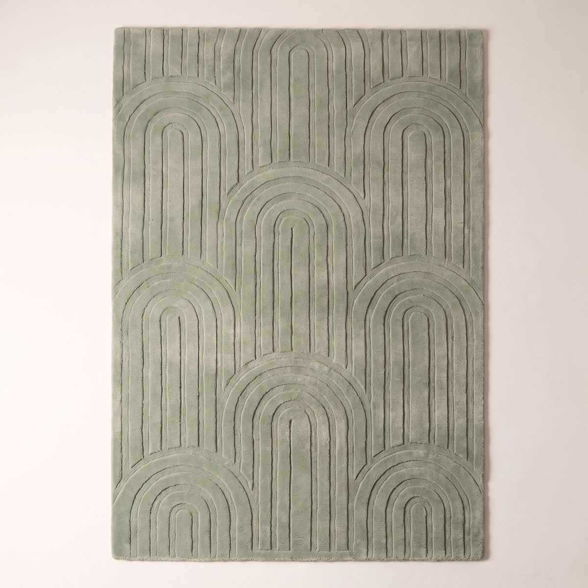 Vault Sage Rug in sage green wool, overhead flat lay showing the full carved arch pattern
