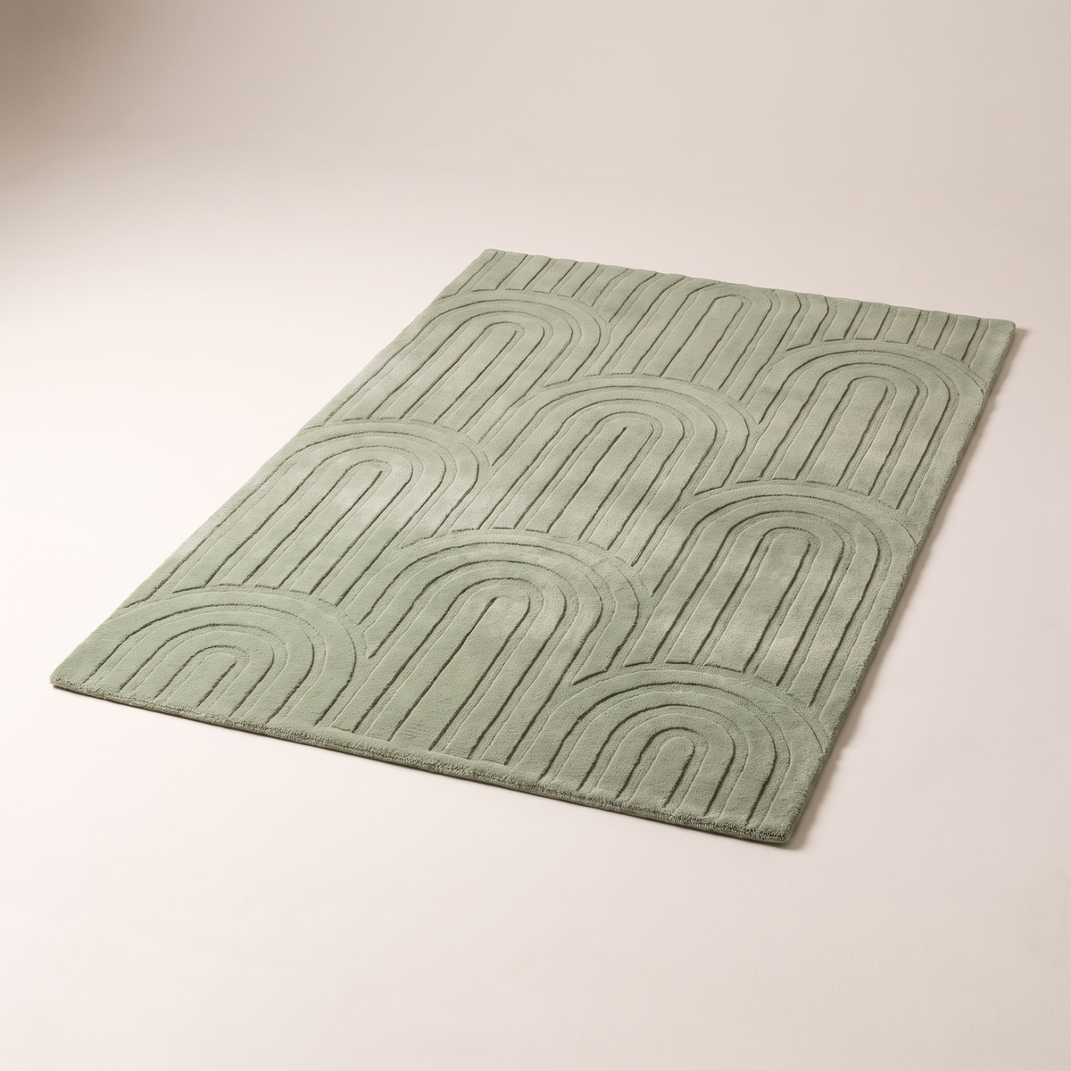 Vault Sage Rug in sage green hand-tufted wool with carved tone-on-tone arch pattern, elevated three-quarter view