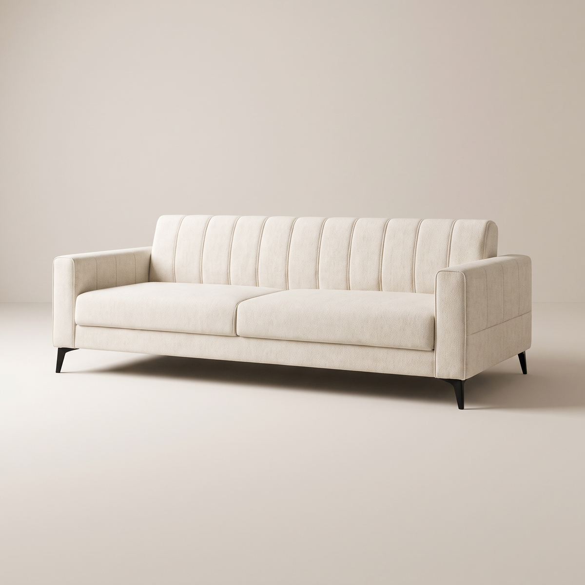 Vela Ivory sofa in ivory cream upholstery with channel-tufted back, track arms and black metal legs, three-quarter view