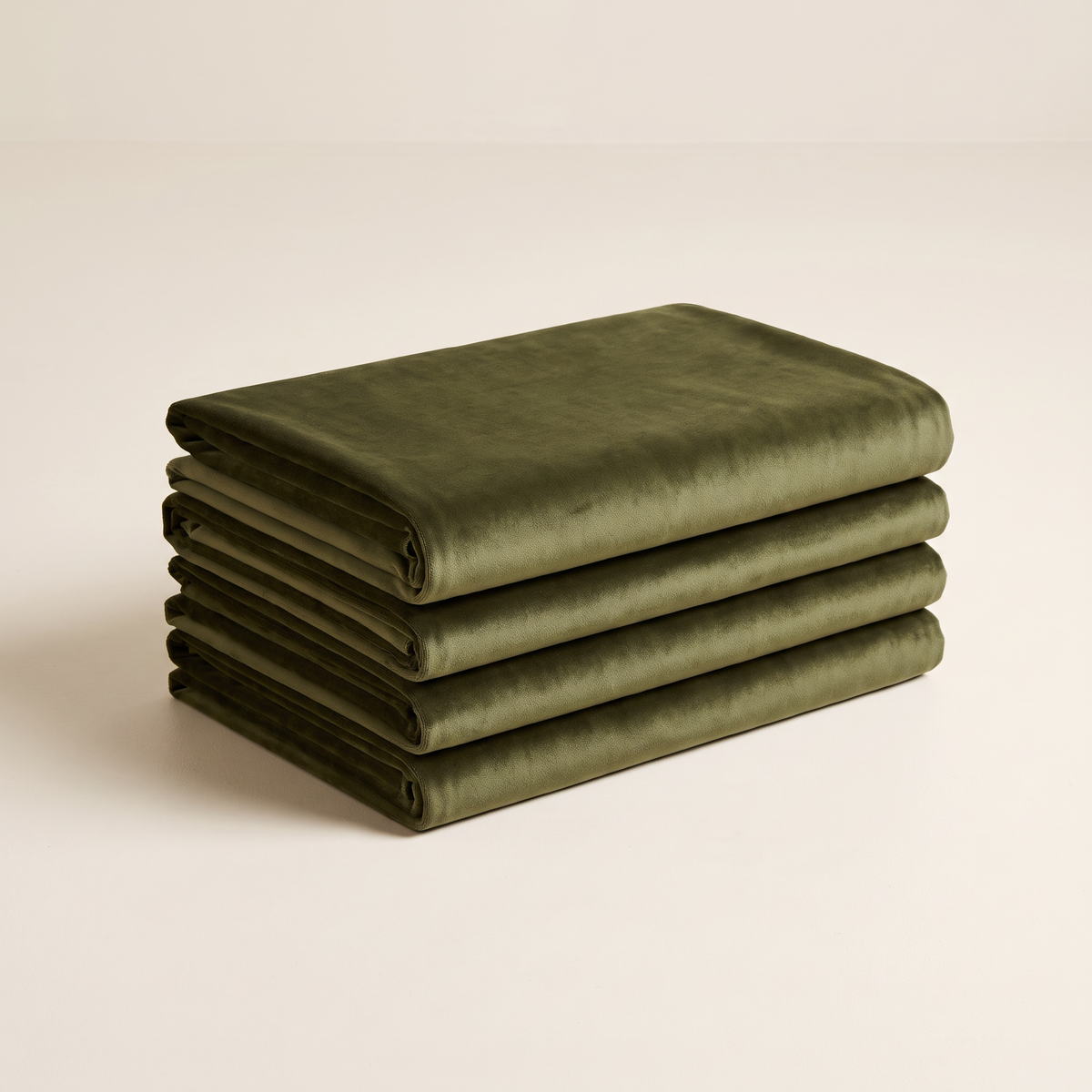 Velvet Olive upholstery fabric, neatly folded stack in deep olive velvet