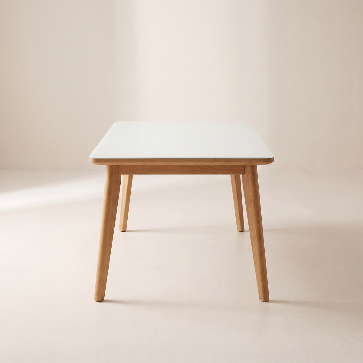 Vista Dining Table with white glass top and light wood frame, end view
