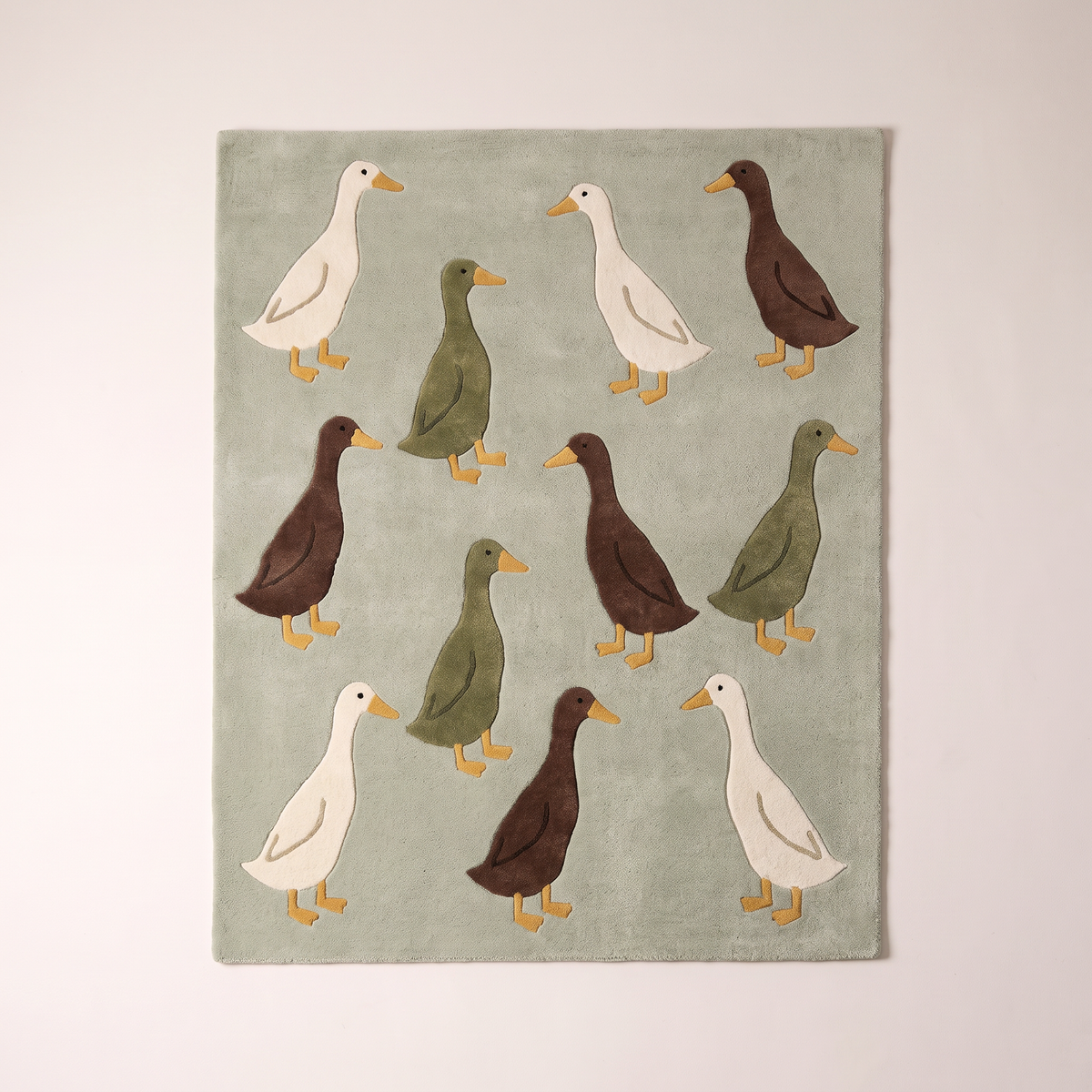 Waddle Kids Rug overhead flat lay showing the duck pattern on a pale sage ground