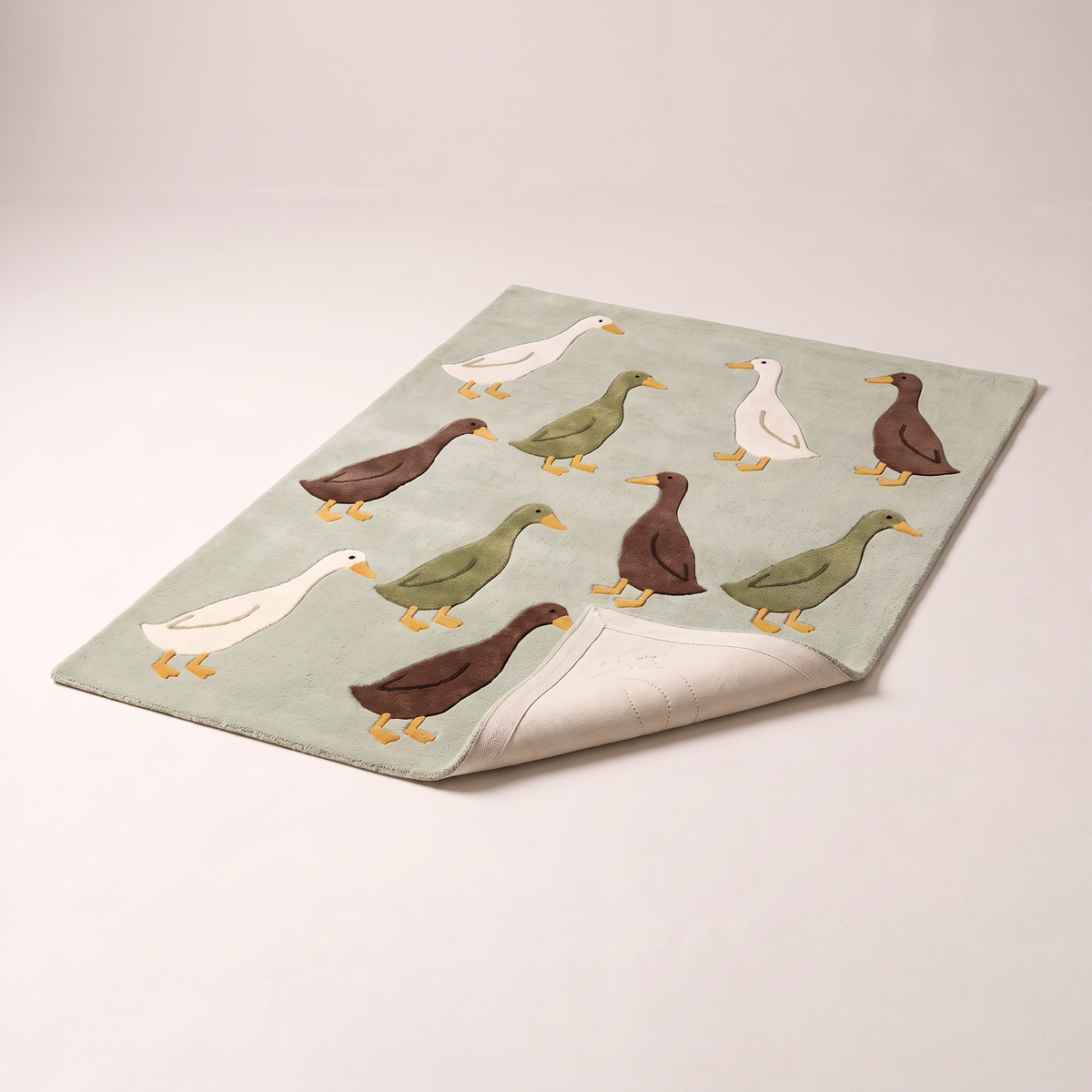 Waddle Kids Rug with a corner folded back to show the cotton backing and edge finish