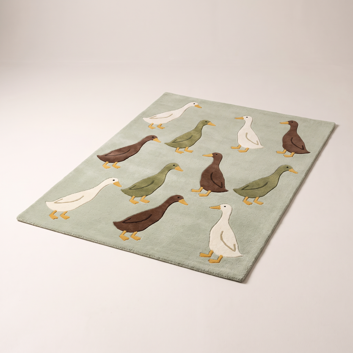 Waddle Kids Rug, hand-tufted sage wool with illustrated cream, olive and brown runner ducks, elevated three-quarter view