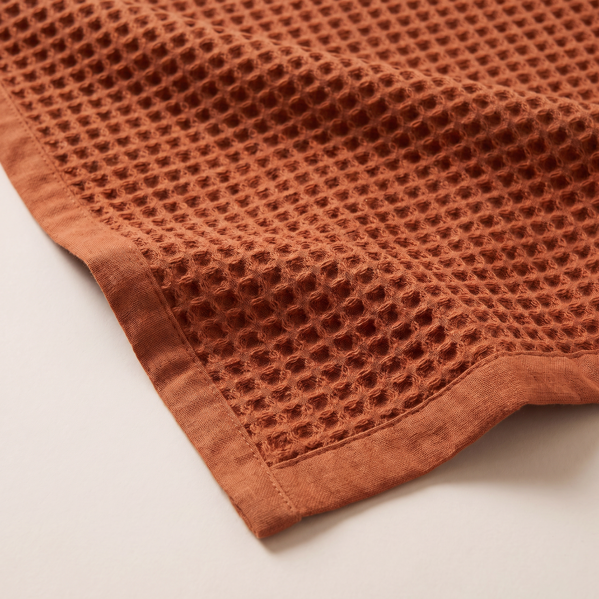 Waffle Cotton Throw close-up of the rust square waffle cells and plain hem