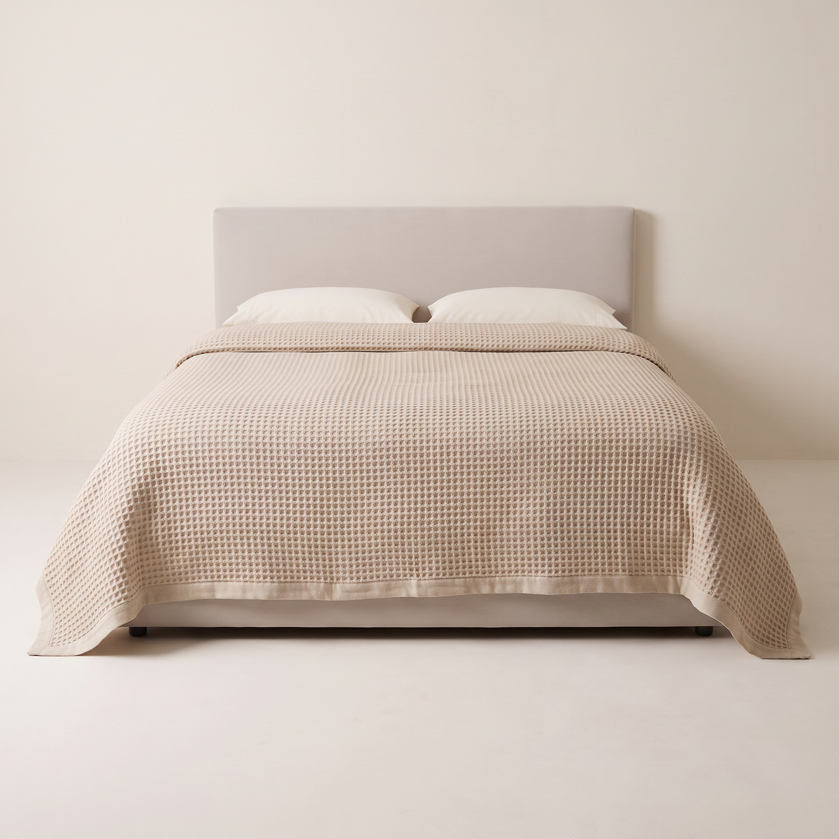 Waffle Weave Bedcover in oat cotton waffle, view from the foot of the bed